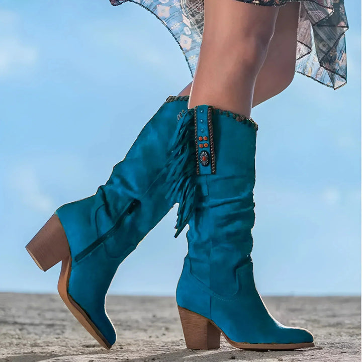 Close-up view of decorative fringe and classic pointed toe on western fashion boots