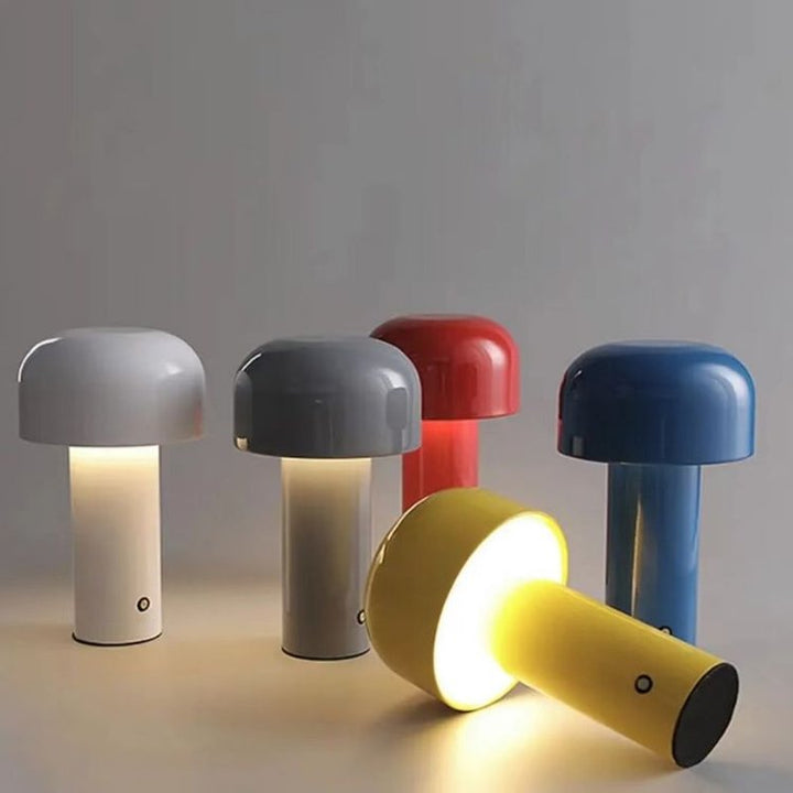 Five colorful mushroom-shaped table lamps displayed together on a surface