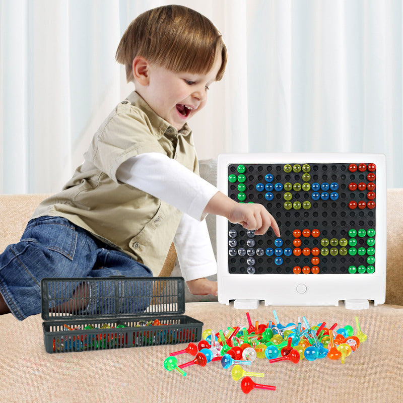 Young boy happily pointing at the glowing rectangular PixelArt board with colorful tiles