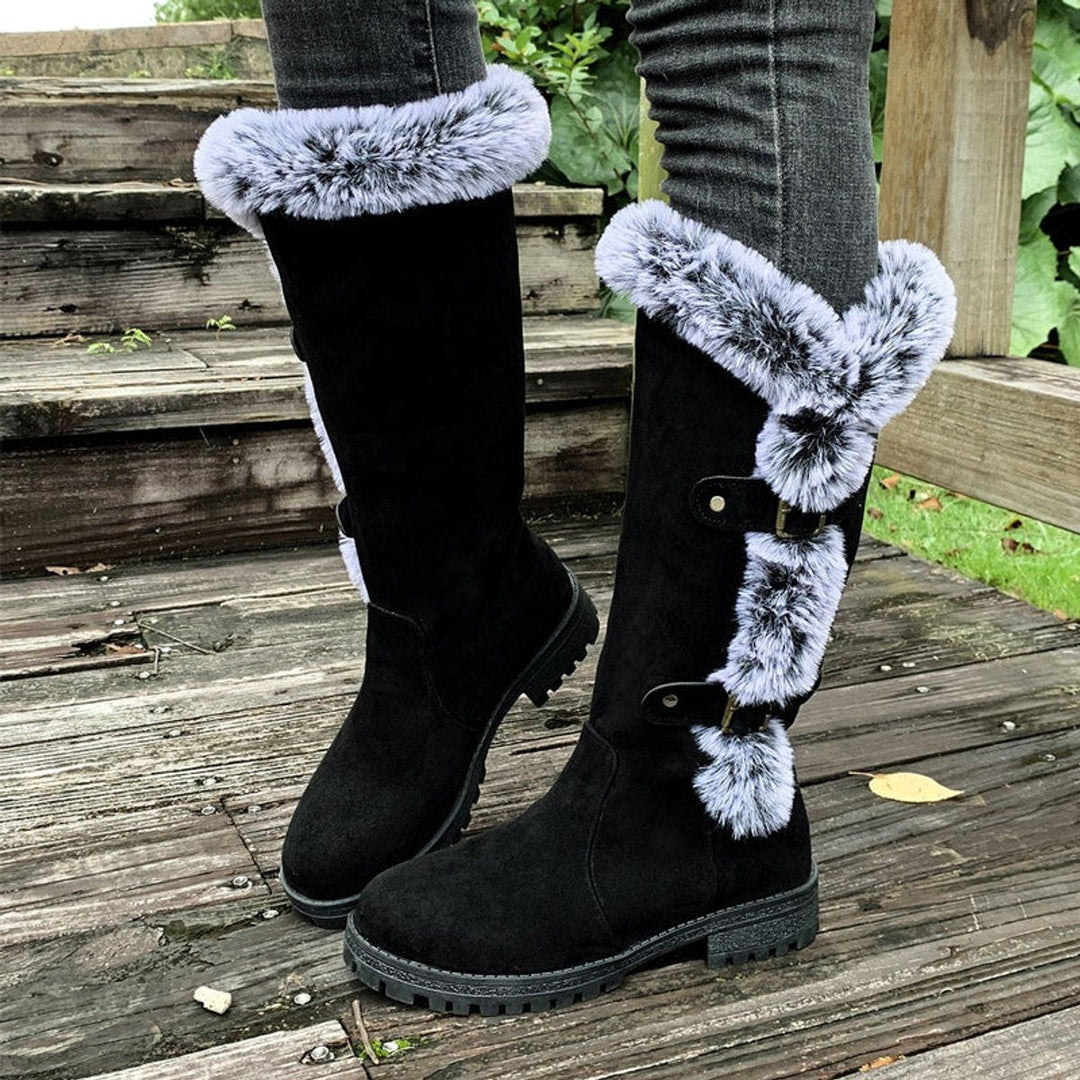 Full length pair of womens fashion knee-high boots standing upright