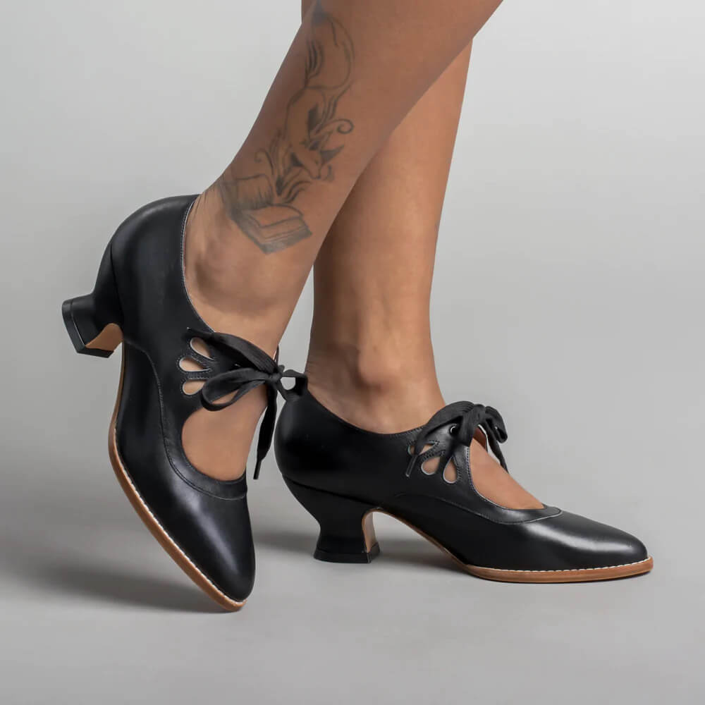 Women's orthopedic low heels in classic black, featuring comfortable arch support for all-day wear.