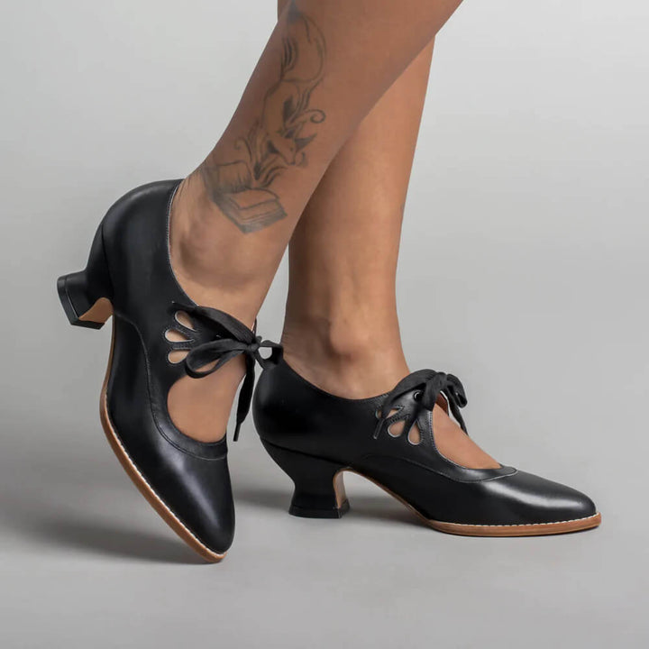Women's orthopedic low heels in classic black, featuring comfortable arch support for all-day wear.