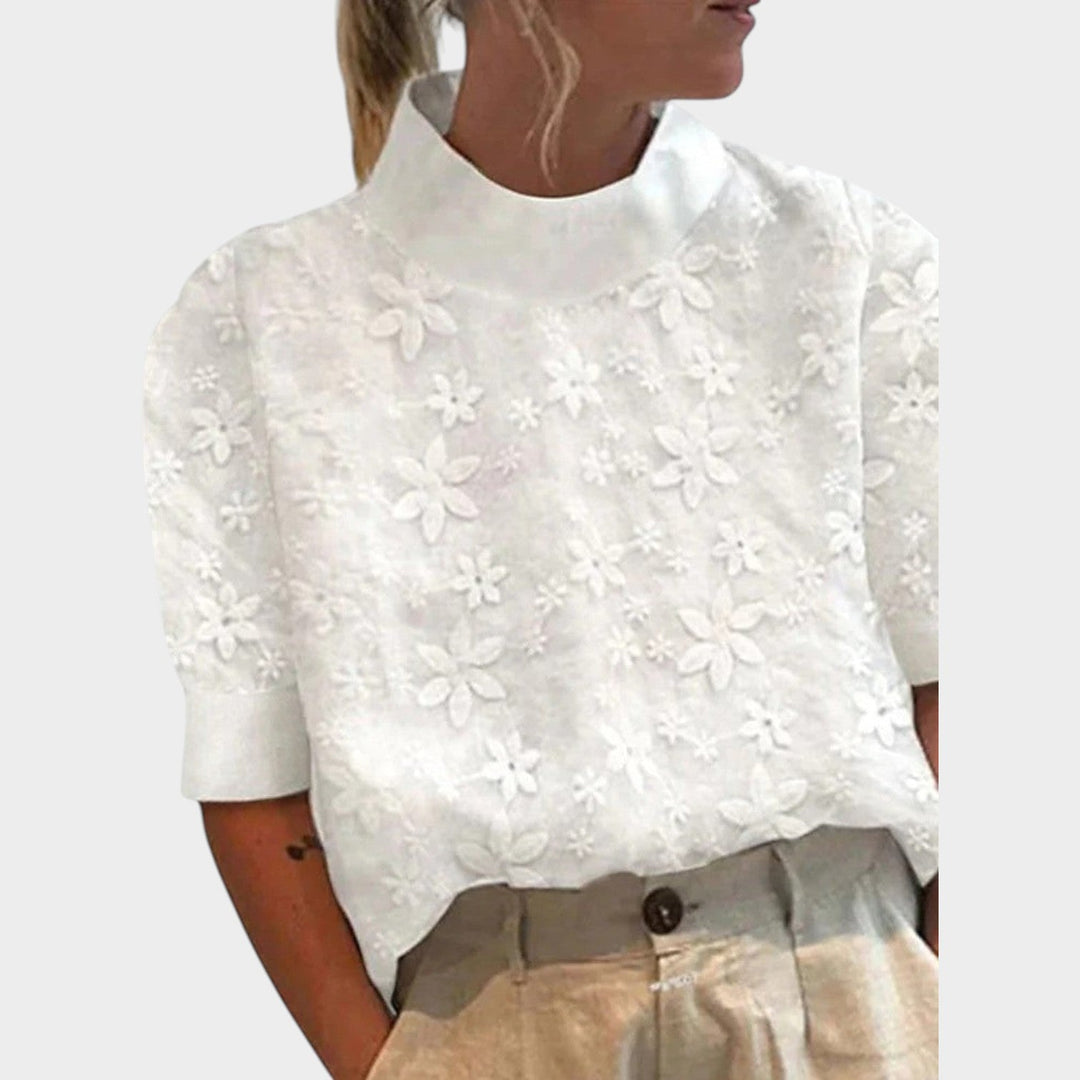 Woman wearing white floral embroidered stand collar short sleeve blouse