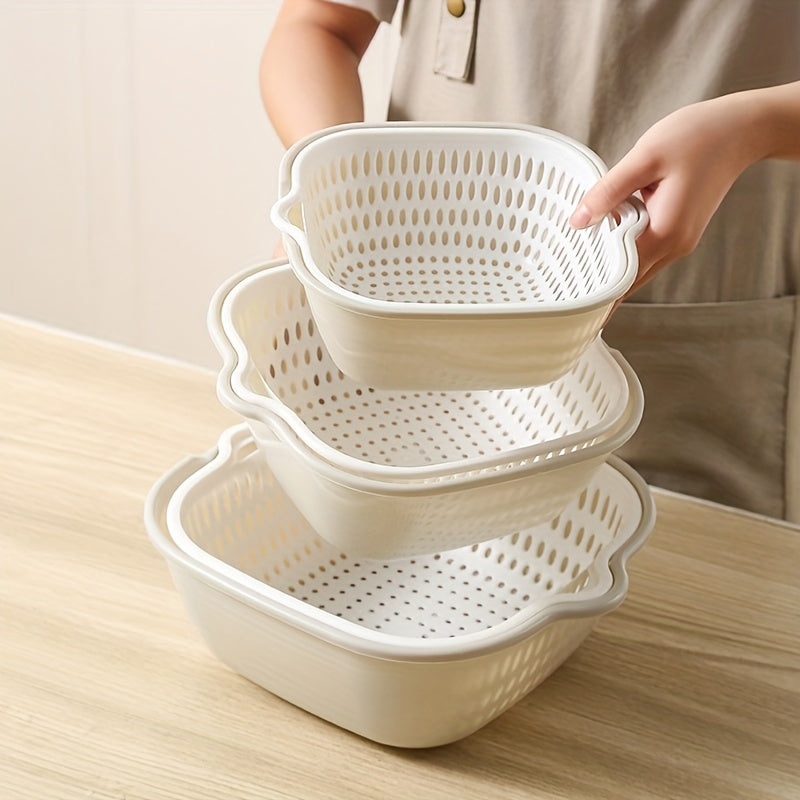 Person holding stacked beige kitchen colanders