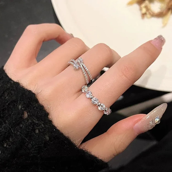Hand wearing the double-layered star and zirconia rings stacked together