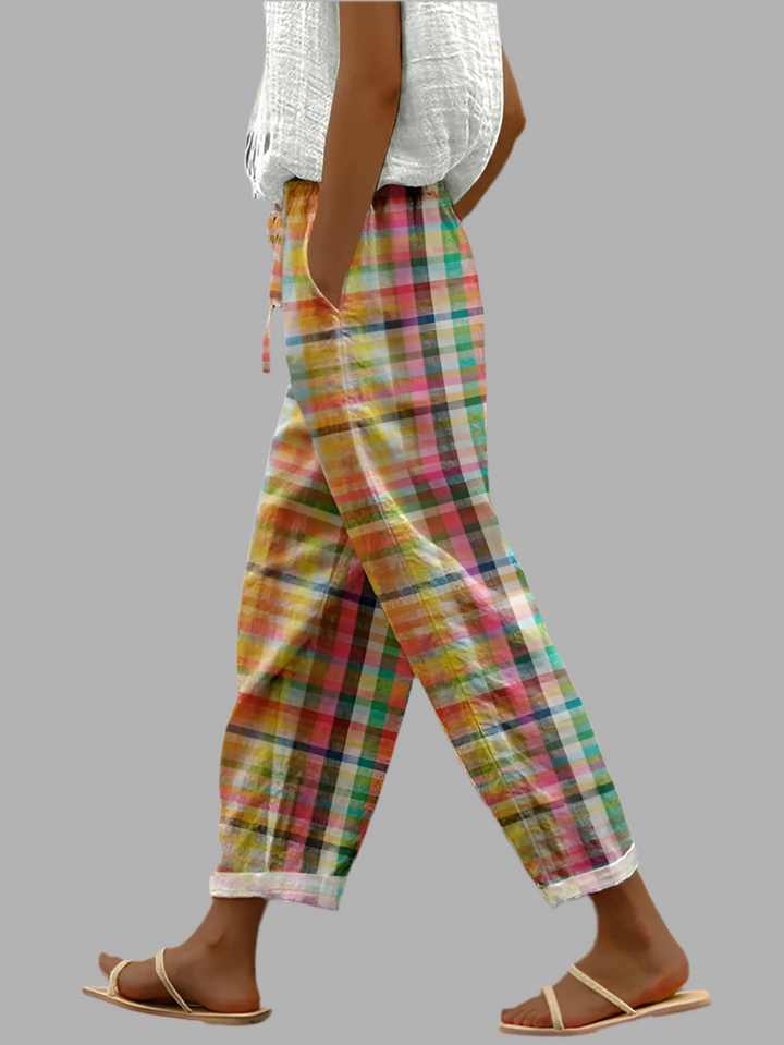 Side profile view of woman wearing multi-color checked trousers