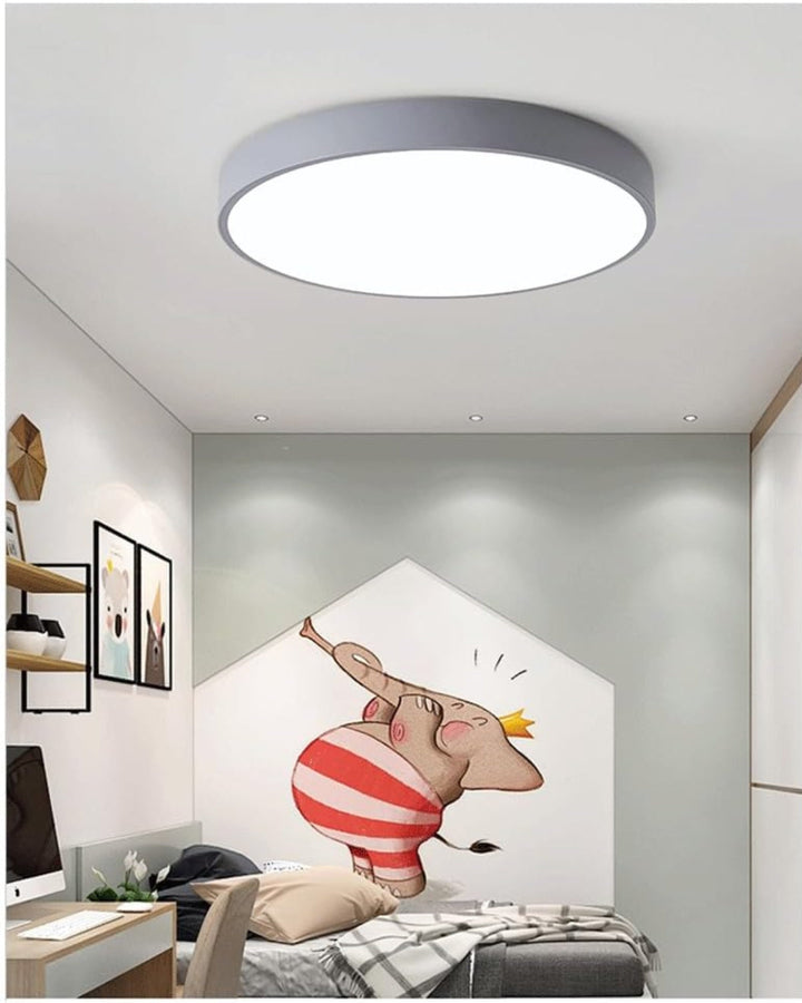 Stylish minimalist disc ceiling lamp mounted on a neutral painted ceiling