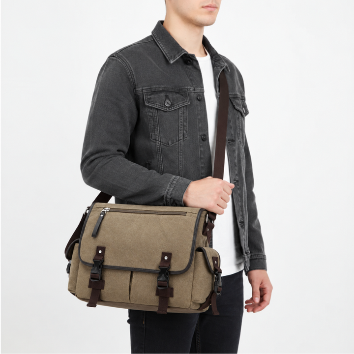 Studio shot of a man wearing a khaki canvas messenger bag with zippered front pocket