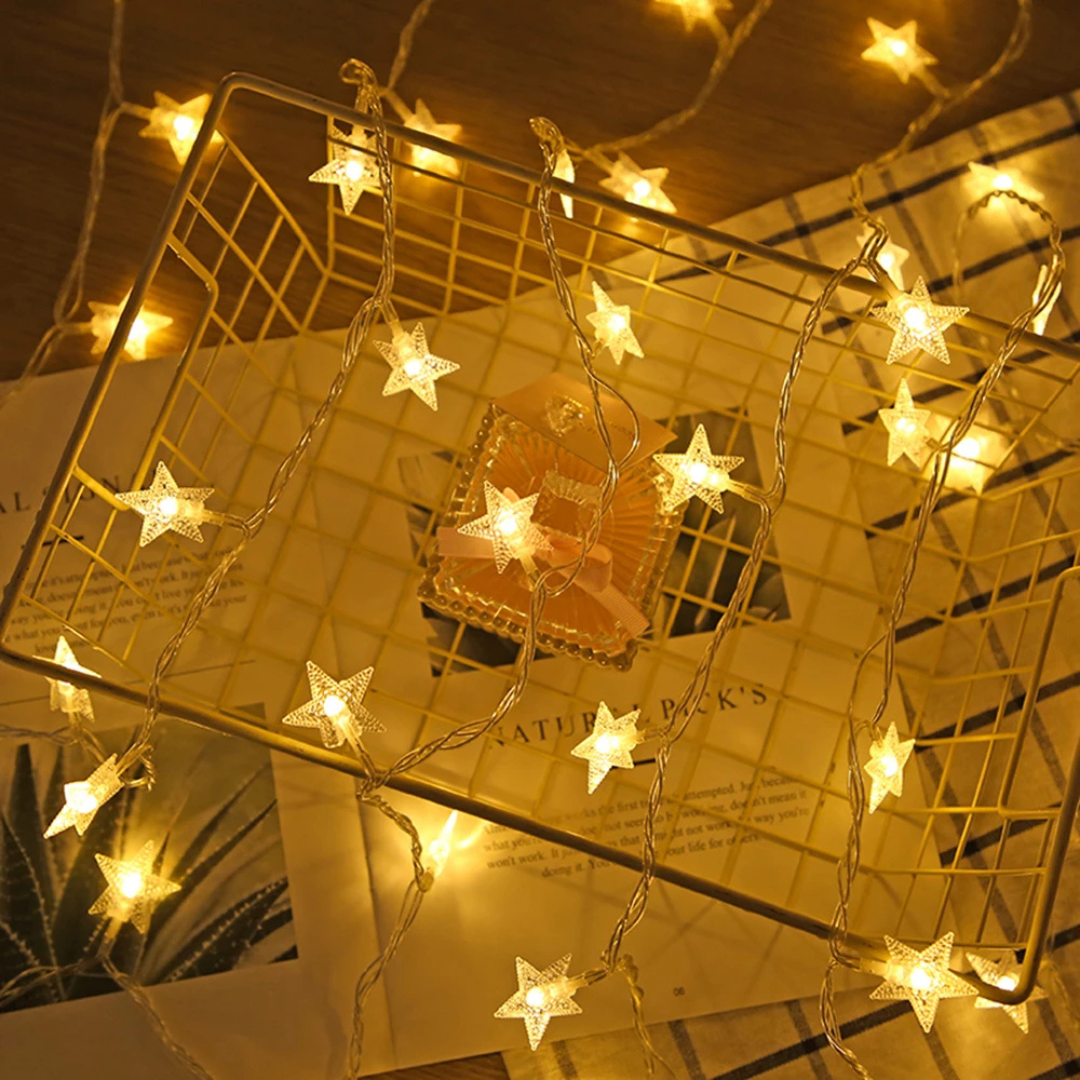 Close-up view of StarLuma star-shaped fairy lights resting on a table surface