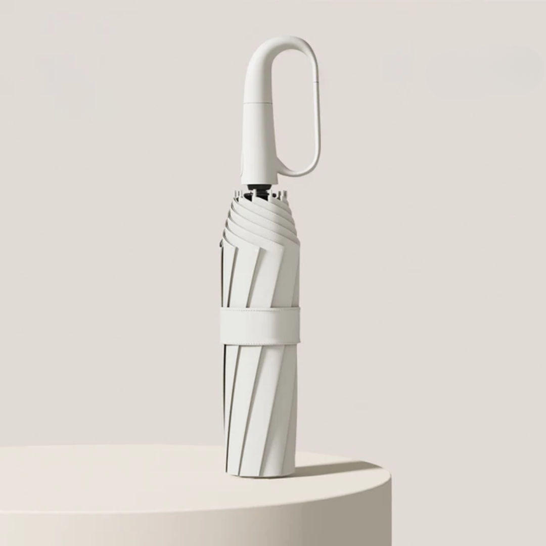 Compact travel umbrella folded down with wrist strap, ready for packing