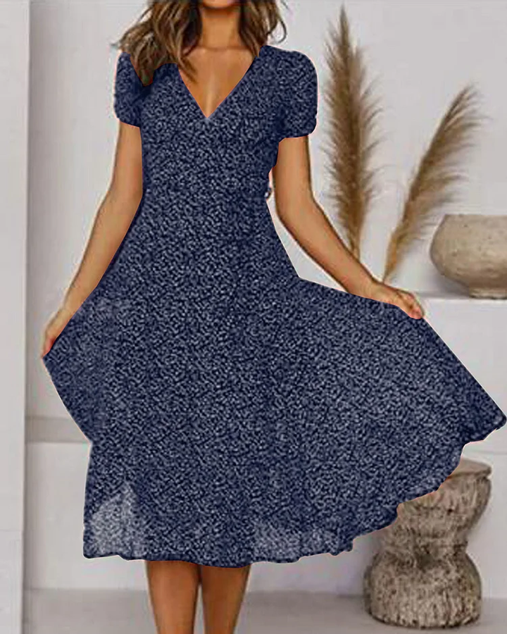 Close up of fabric and puff sleeve detail on a womens midi party dress