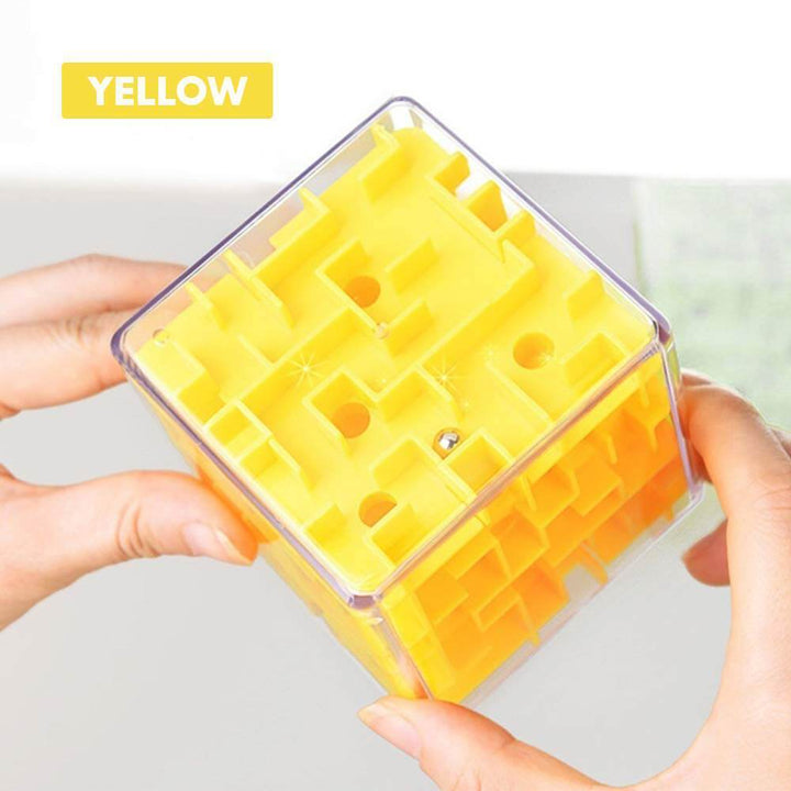 Brain teaser maze cube educational toy held in hands to demonstrate its compact size.