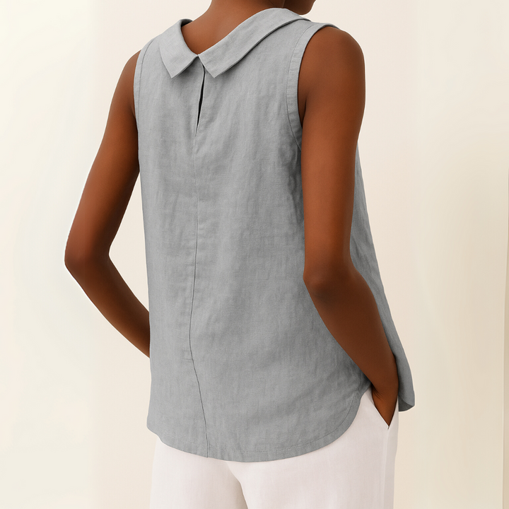 Back view of a model wearing a grey sleeveless roll collar relaxed summer top showing the collar detail