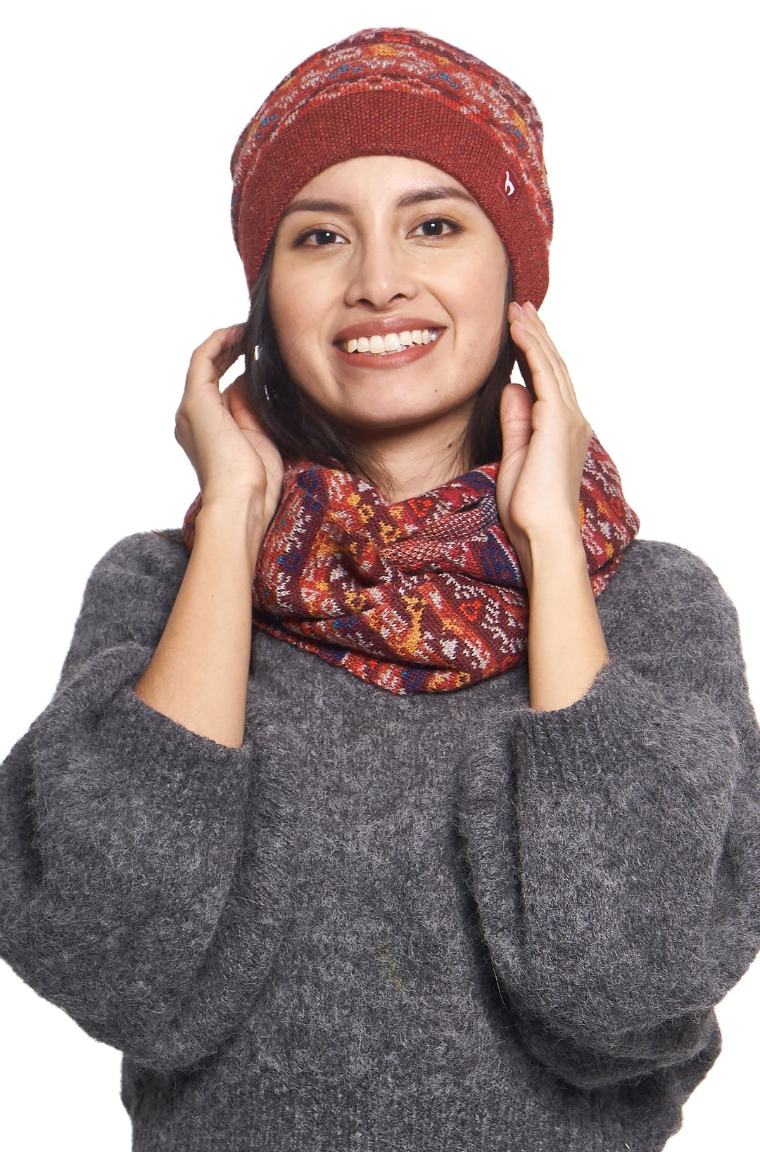 Smiling woman showcasing red jacquard knit cold-weather beanie