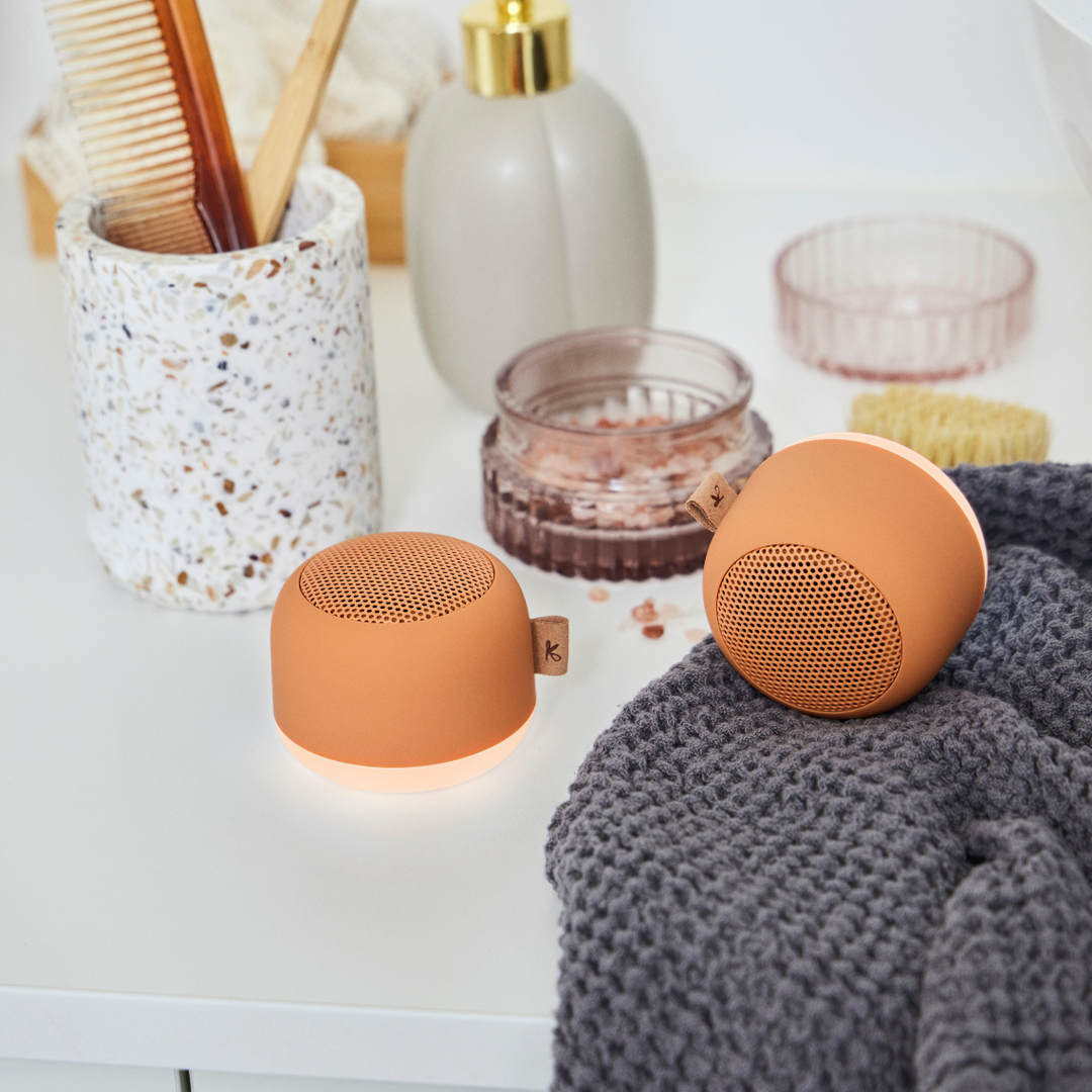 Color-changing mood light feature activated on a compact shower speaker