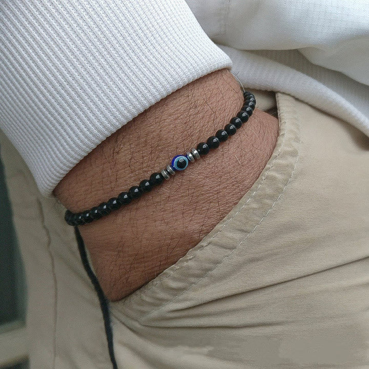 Casual mens stone bracelet featuring protective evil eye charm