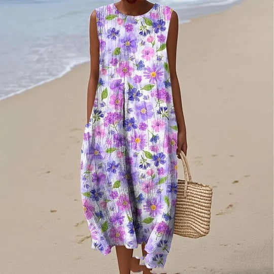 Woman wearing a purple floral spring dress on a sandy beach