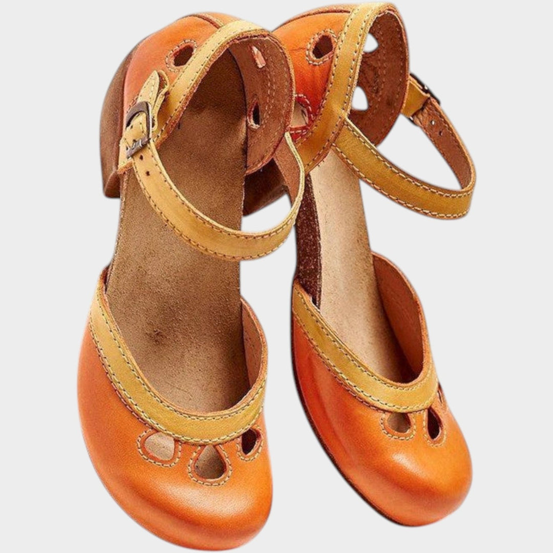 Pair of orange vintage cut-out block heel sandals viewed from above