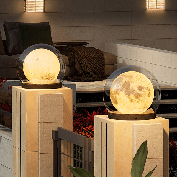 Outdoor moon-style lamp mounted on a pillar at night