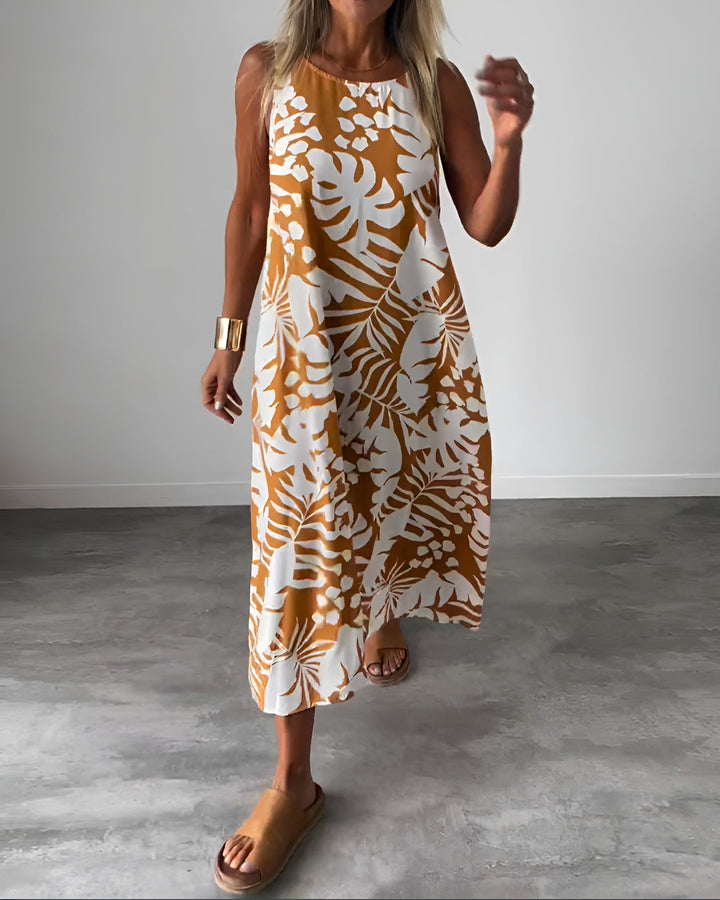 Woman wearing the Audrey elegant sleeveless dress in brown with botanical print