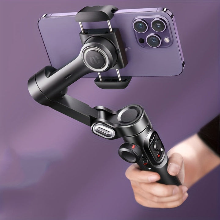 Close-up of a hand holding a 3-axis smartphone gimbal with a phone mounted