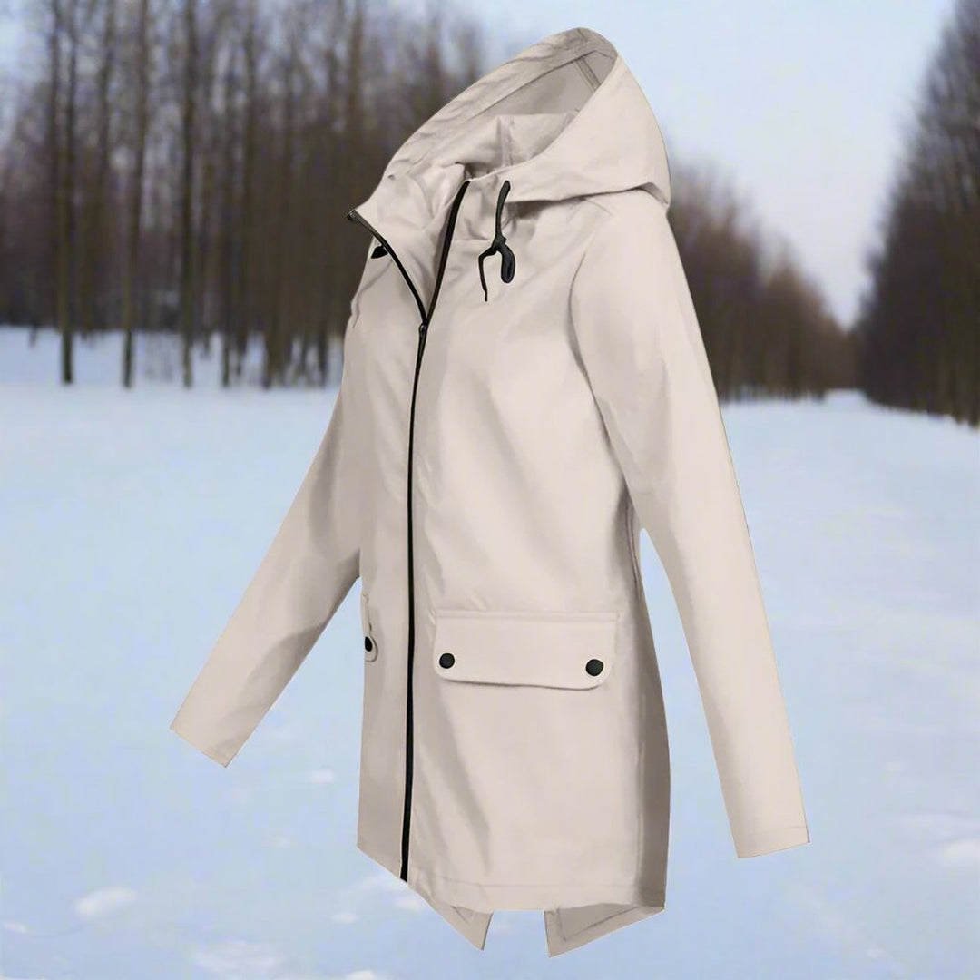 Apricot waterproof hooded rain jacket front view in snowy forest setting
