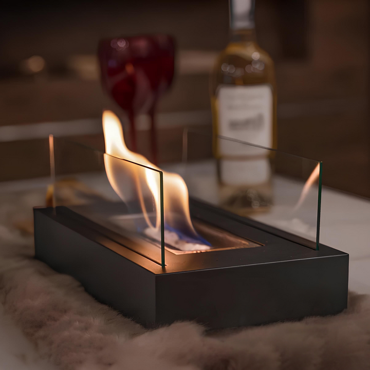 Black FireGlow tabletop bio-ethanol fireplace creating a cozy flame indoors