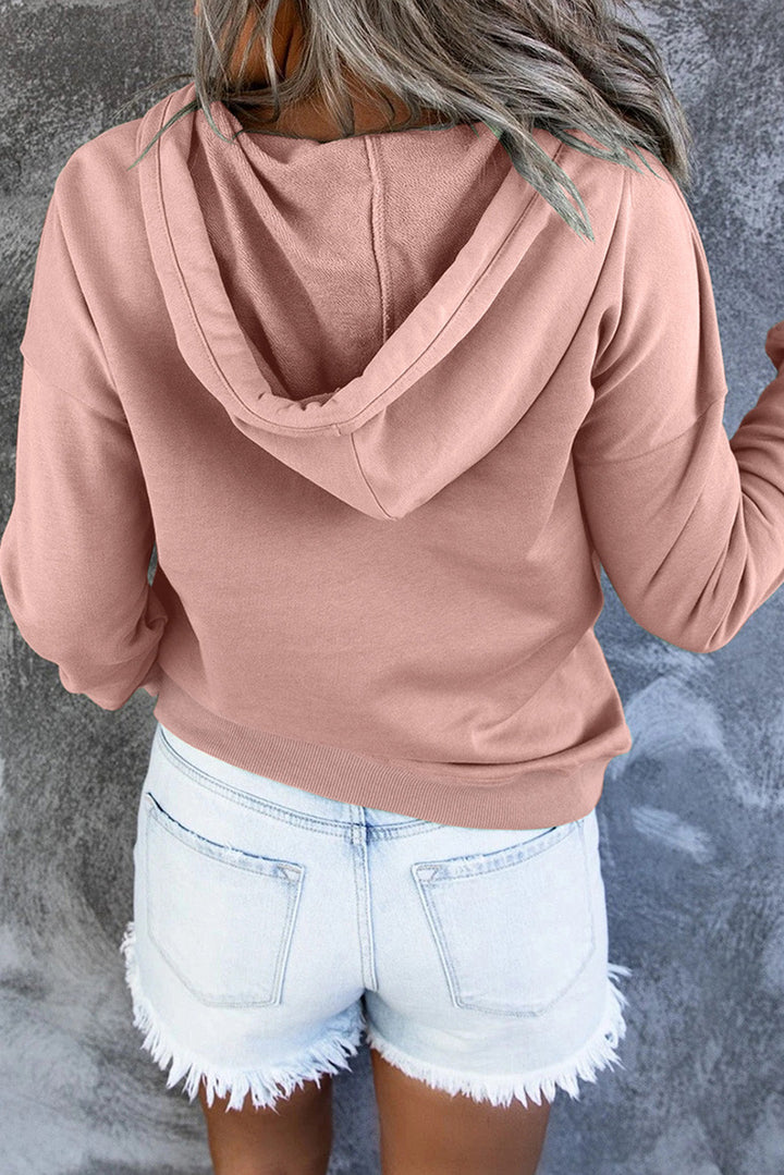 Back view of woman wearing cozy hooded sweater showing regular fit and length