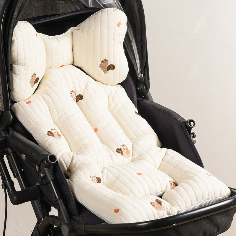 Detailed view of universal harness openings on a breathable baby seat pad