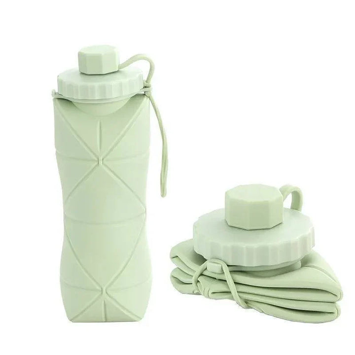 Green 600ml collapsible silicone water bottle shown fully expanded and folded flat