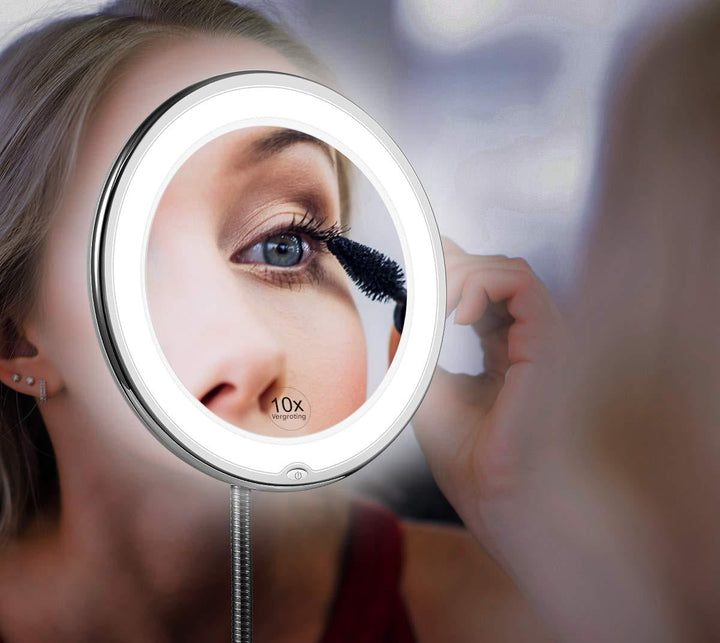Woman applying makeup using a 10X LED magnifying mirror