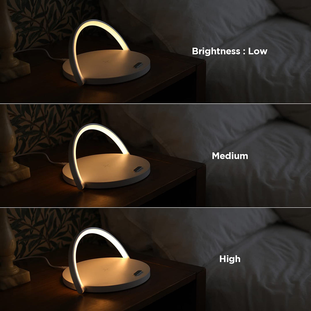 Modern bedside LED table lamp and wireless smartphone charger on a nightstand