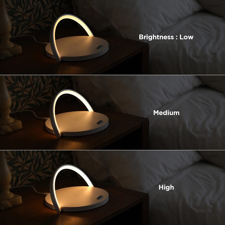 Modern bedside LED table lamp and wireless smartphone charger on a nightstand
