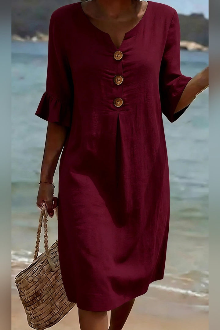 Detailed shot of V-neckline on the women's button dress