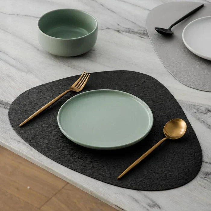 Modern silver tableware kitchenware set arranged neatly on a neutral background