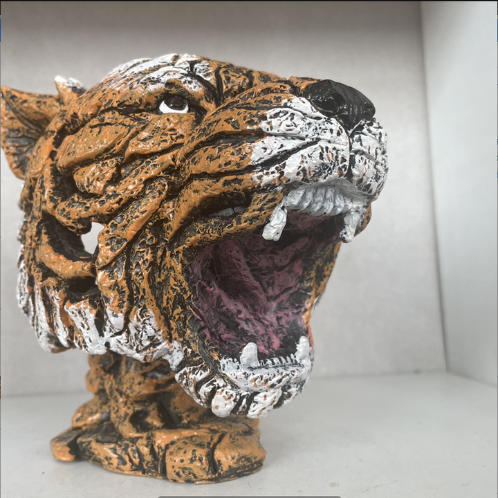 Close up of tiger animal sculpture head showing hand-painted texture
