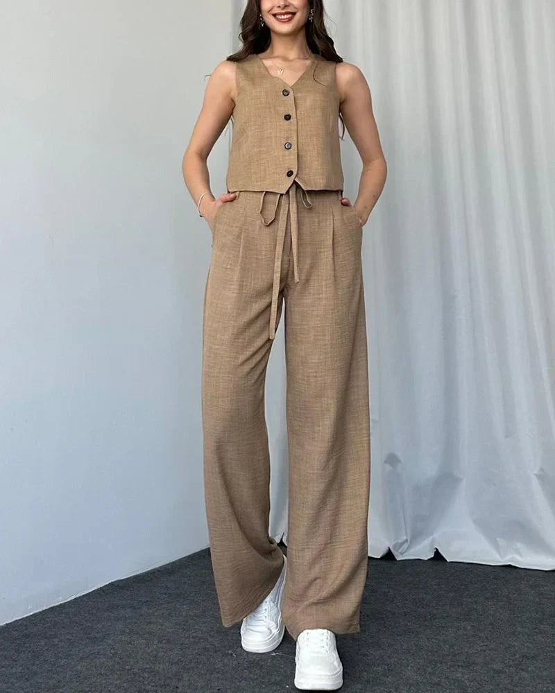 Woman wearing beige two-piece button vest and matching trousers facing forward