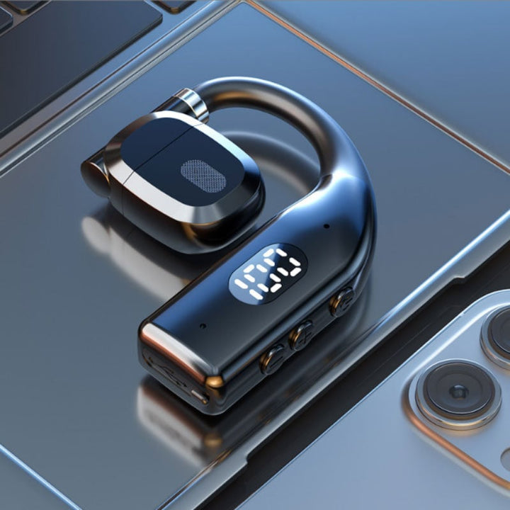 Beige open-ear wireless headset paired with charging dock