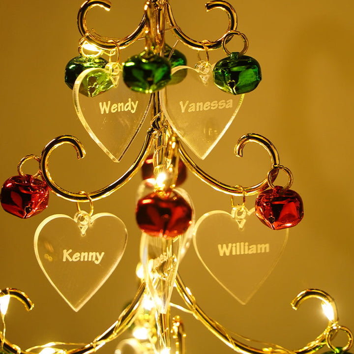 Close-up of wooden personalized engraved Christmas tree holiday decor showing detailed name cutting