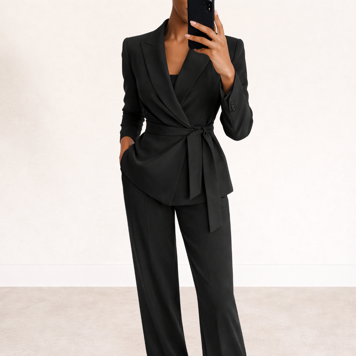 Woman wearing black blazer suit set with wide leg trousers and belt