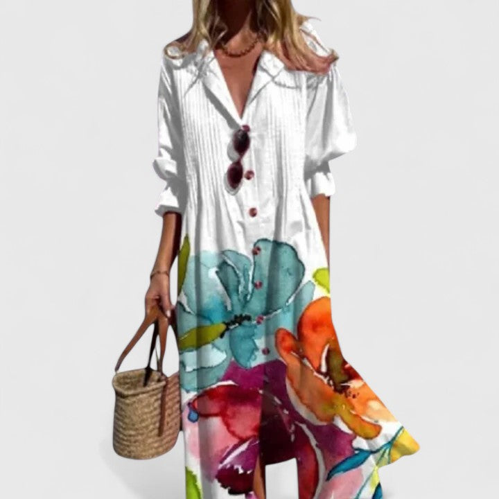 Woman wearing white leaf print maxi shirt dress holding a woven bag