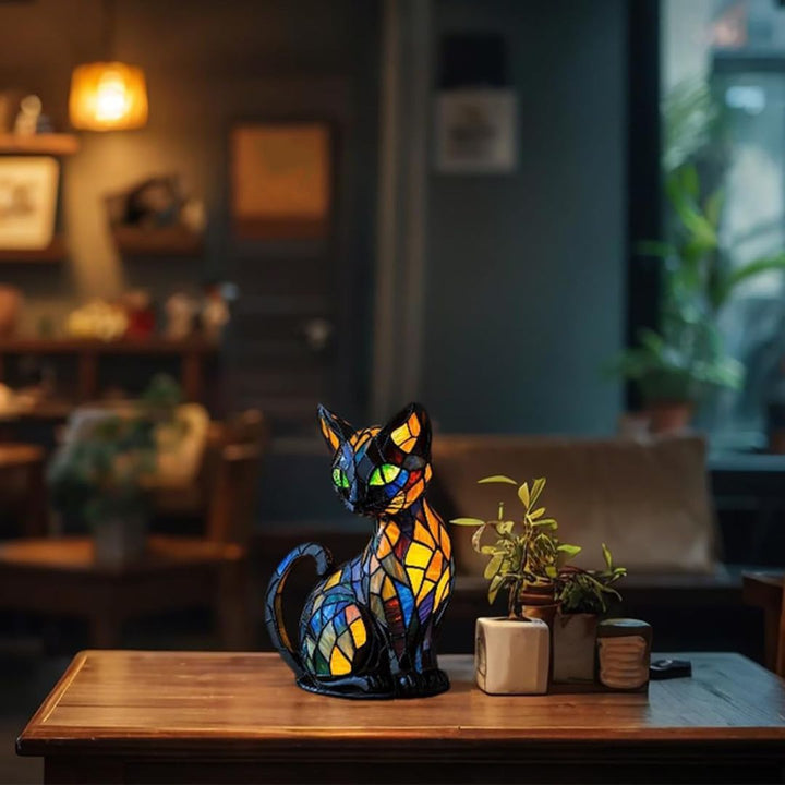 Decorative mosaic cat table lamp glowing with warm ambient light on a nightstand