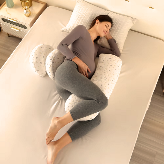 Pregnant woman sleeping peacefully using the ergonomic U-shaped pregnancy pillow