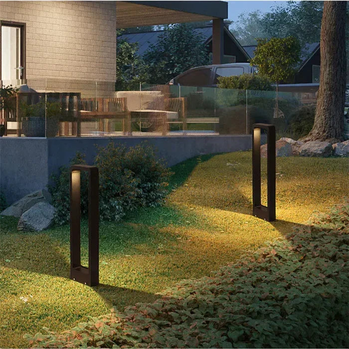Landscape lighting ground spotlight illuminating modern home exterior wall at night