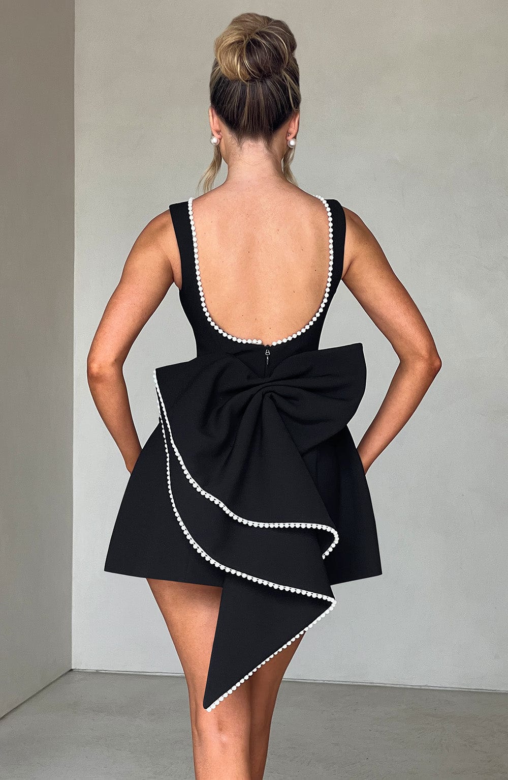 Side profile of stylish a-line cocktail dress with delicate pearl accents