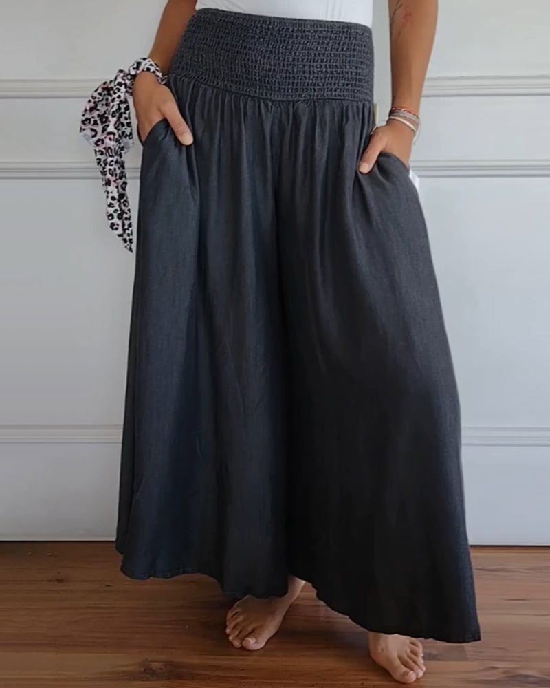 Woman wearing a dark gray flowy elastic waist skirt with pockets