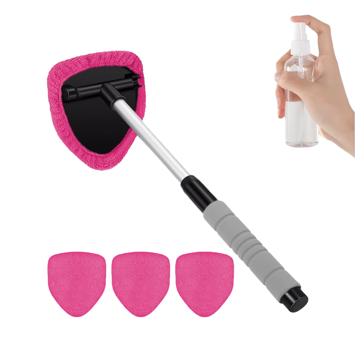 Double-sided magnetic car window cleaner cleaning a windshield
