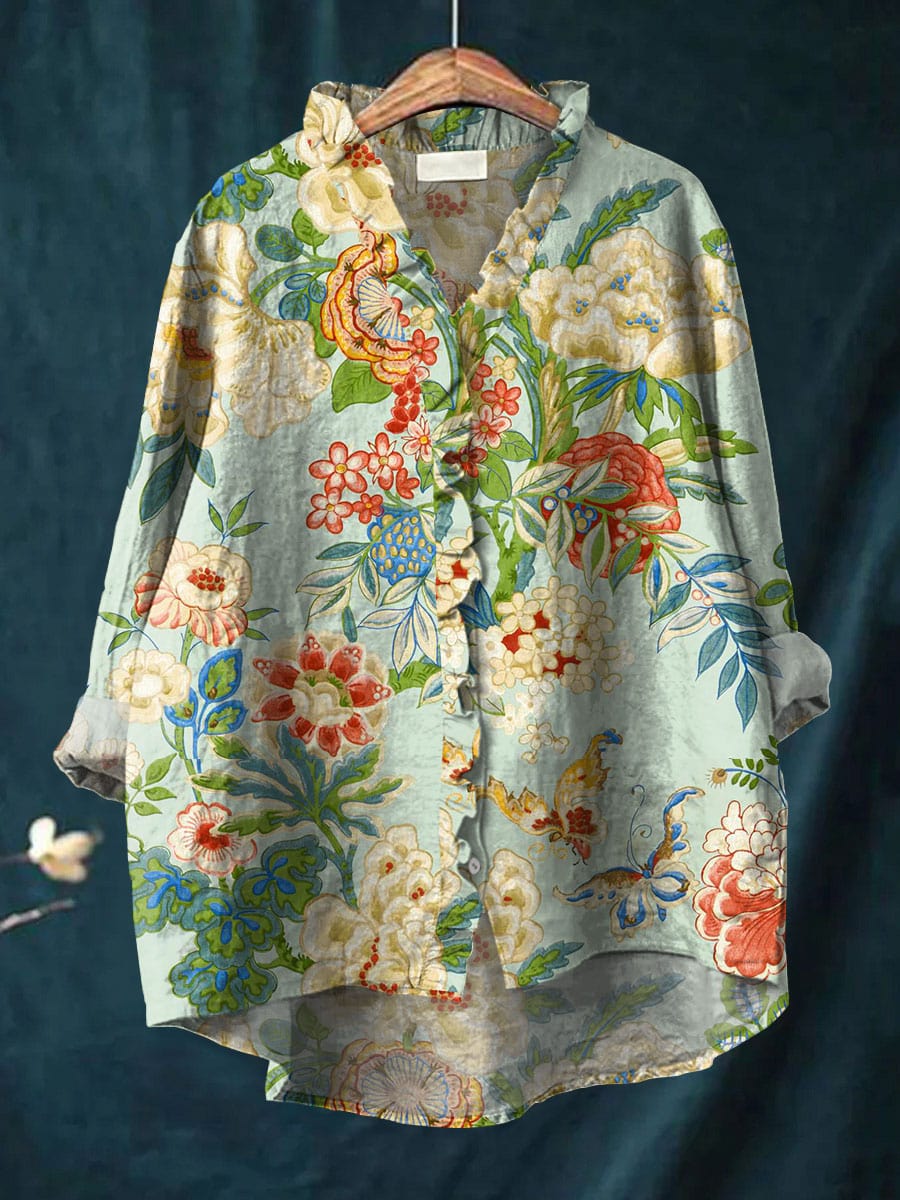 Women's floral print long sleeve blouse in green on a hanger