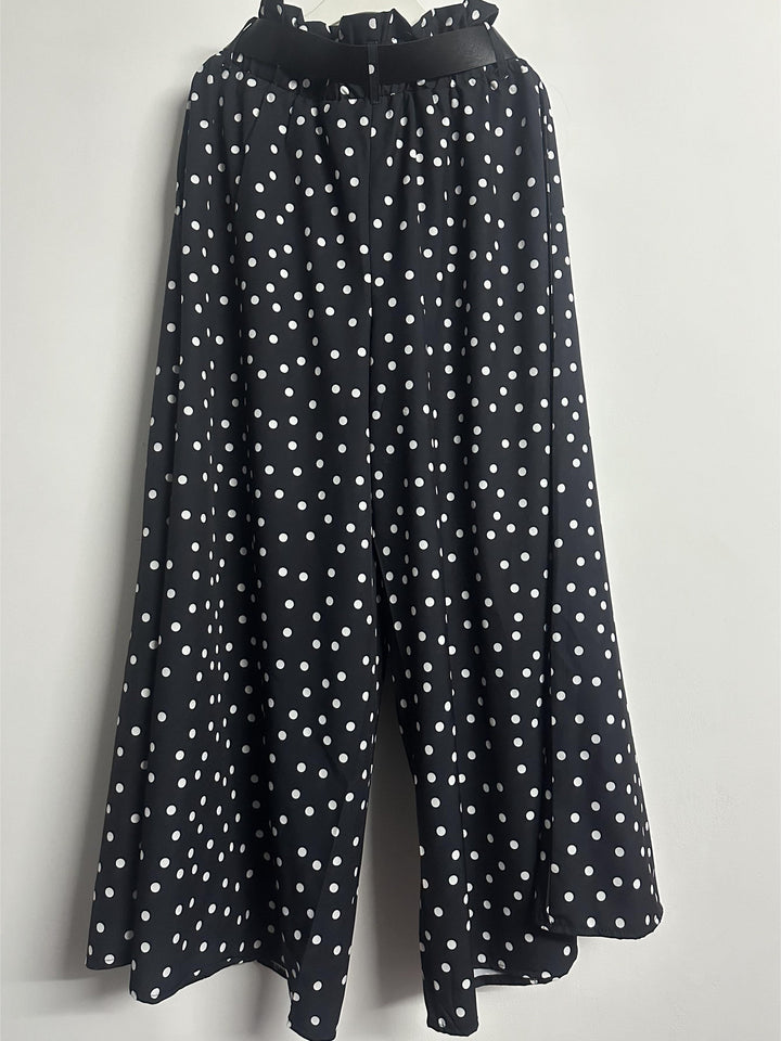 Plus size polka dot wide-leg trousers back view showing high waist and curve fit