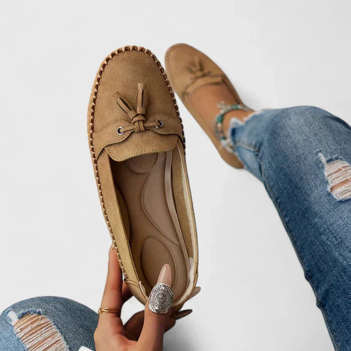 Side view of bow loafers moccasins with flat sole